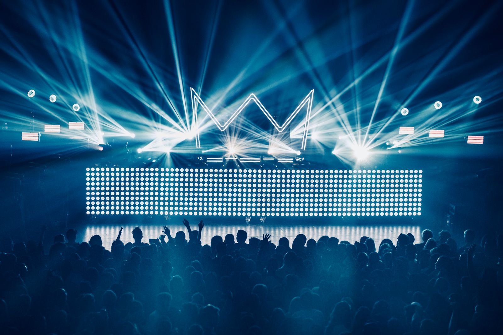 Dancers in silhouette against a lit stage in a club